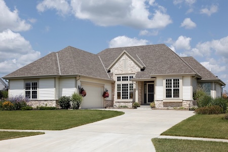 How can driveway cleaning help prevent permanent concrete stains
